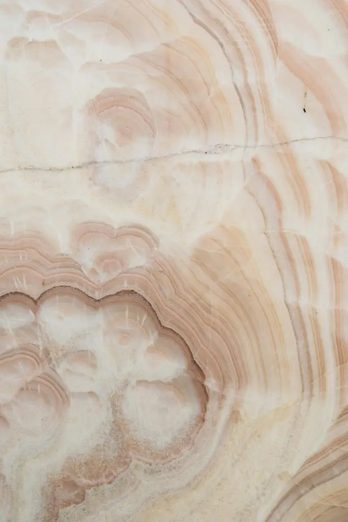 Close-up of textured stone surface showcasing abstract patterns with earthy brown hues.